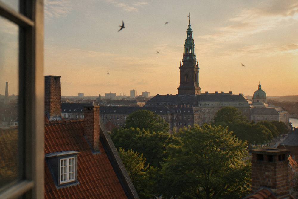 The spire of Christiansborg palace rising above the rooftops of central Copenhagen