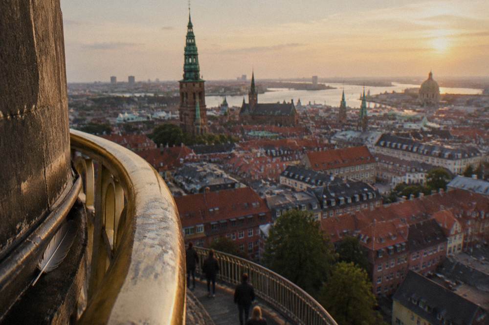Rooftops and church spires of Copenhagen seen from above in soft evening light