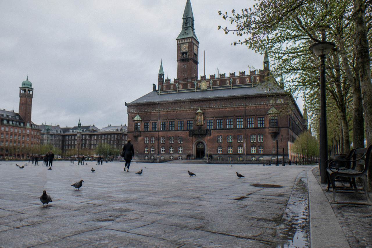 Copenhagen city hall square with an old brick facade and an open plaza