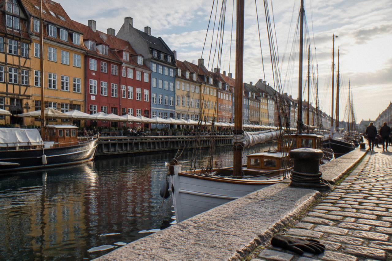 Colourful gabled townhouses along the Nyhavn canal in Copenhagen on a bright day