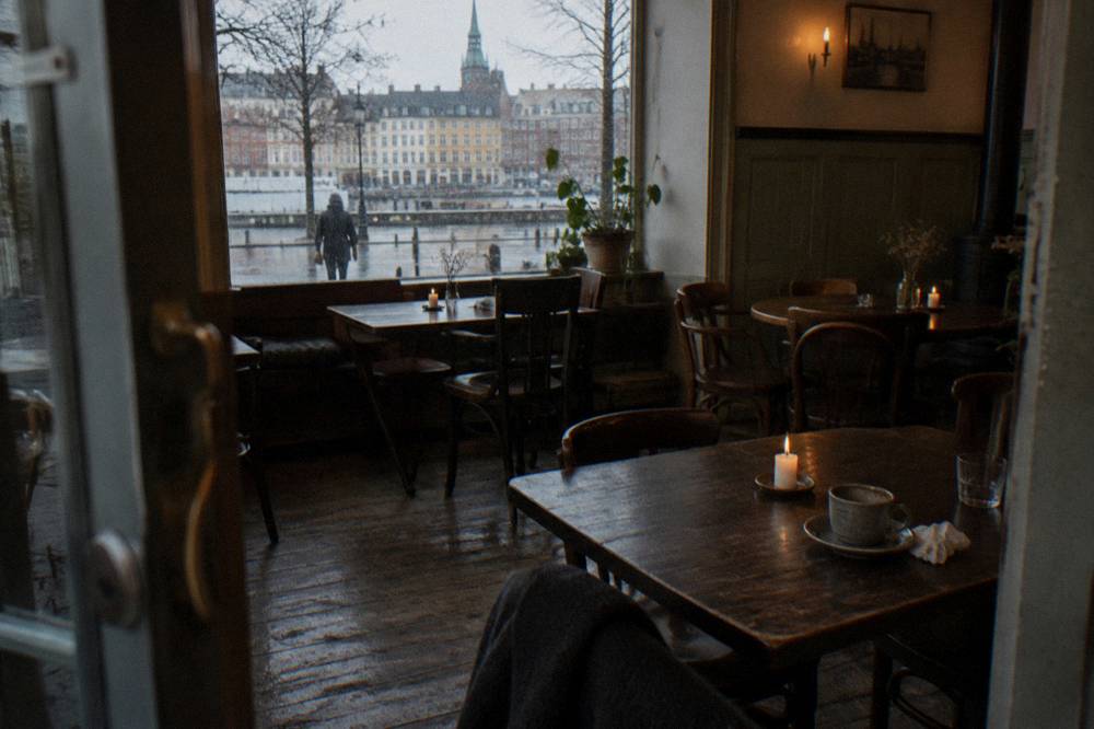 Cozy Copenhagen cafe interior with candles and wooden furniture