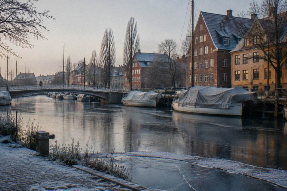 A quiet canal in Christianshavn with wooden bridges and moored boats