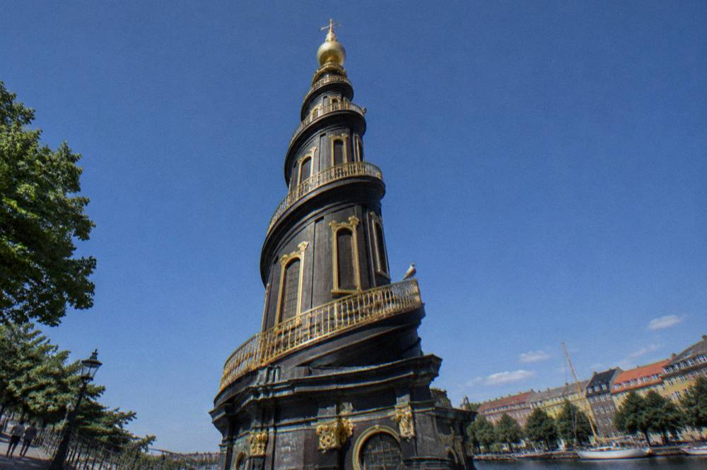 Spiral church tower seen from below against an open sky