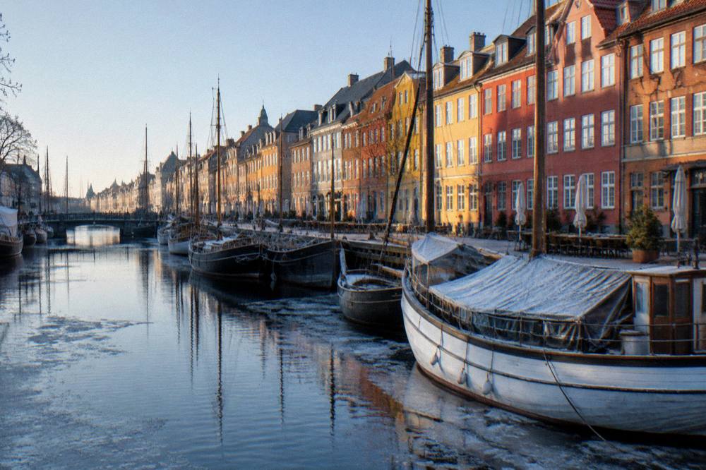 Bridge over the inner harbour with canal boats and coloured townhouses along the water