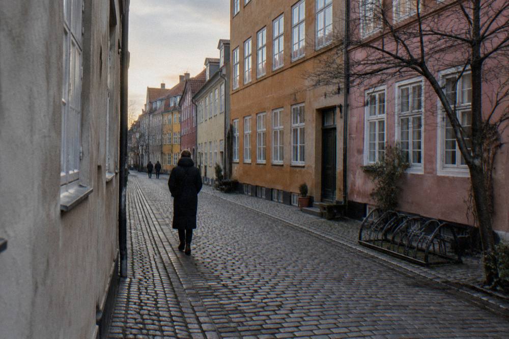 Narrow historic street in central Copenhagen with colourful facades and bicycles
