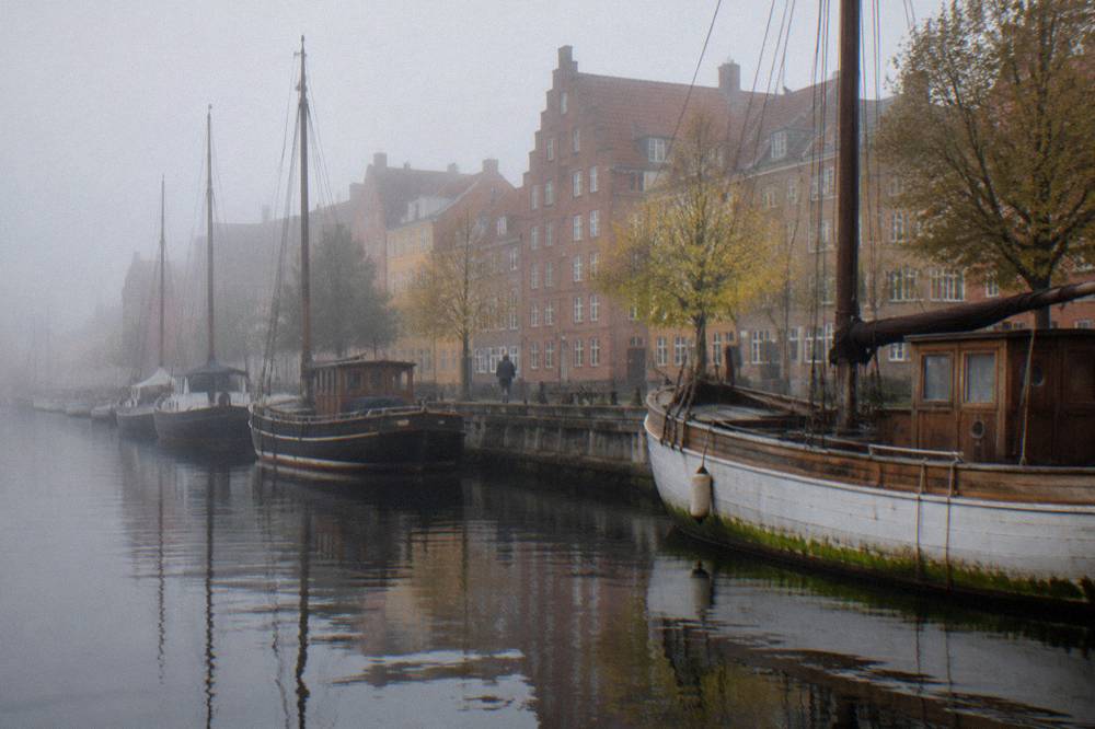 Copenhagen canal in the old town with moored boats and coloured townhouses