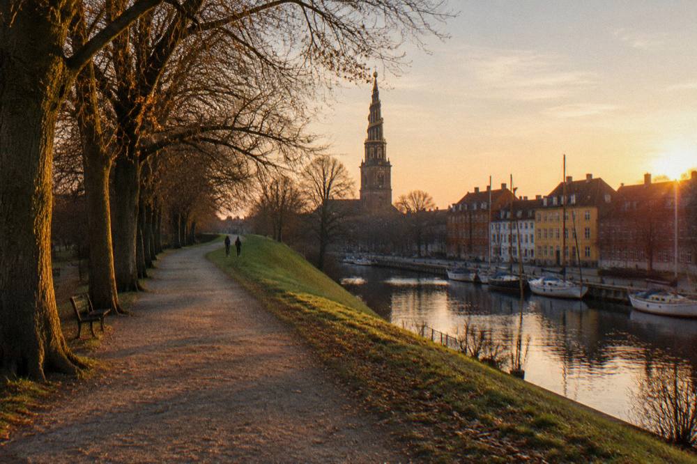 A gravel path and trees along the old Christianshavn rampart at golden hour