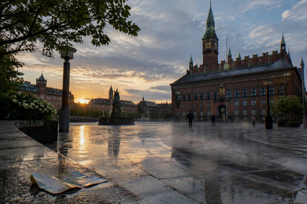 Copenhagen City Hall square with people crossing toward the historic building