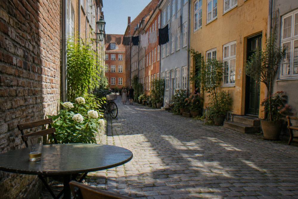 Narrow cobblestone street in the Latin Quarter with pastel townhouses and bicycles leaning against a wall