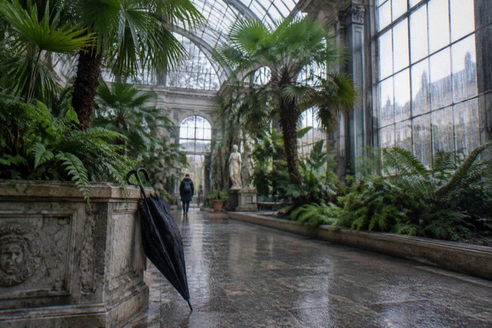 Museum gallery hall with sculptures lit by daylight from a glass roof